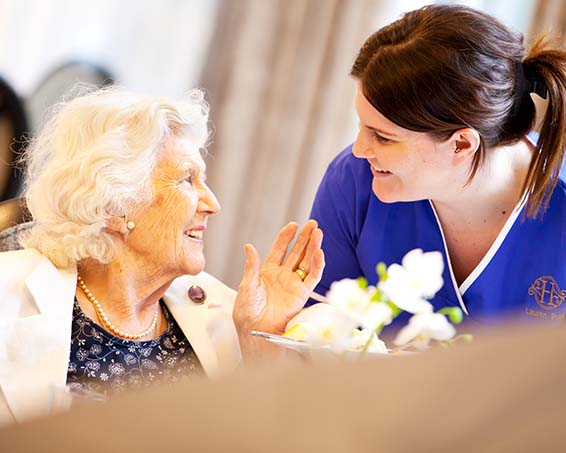 A resident chatting with a carer