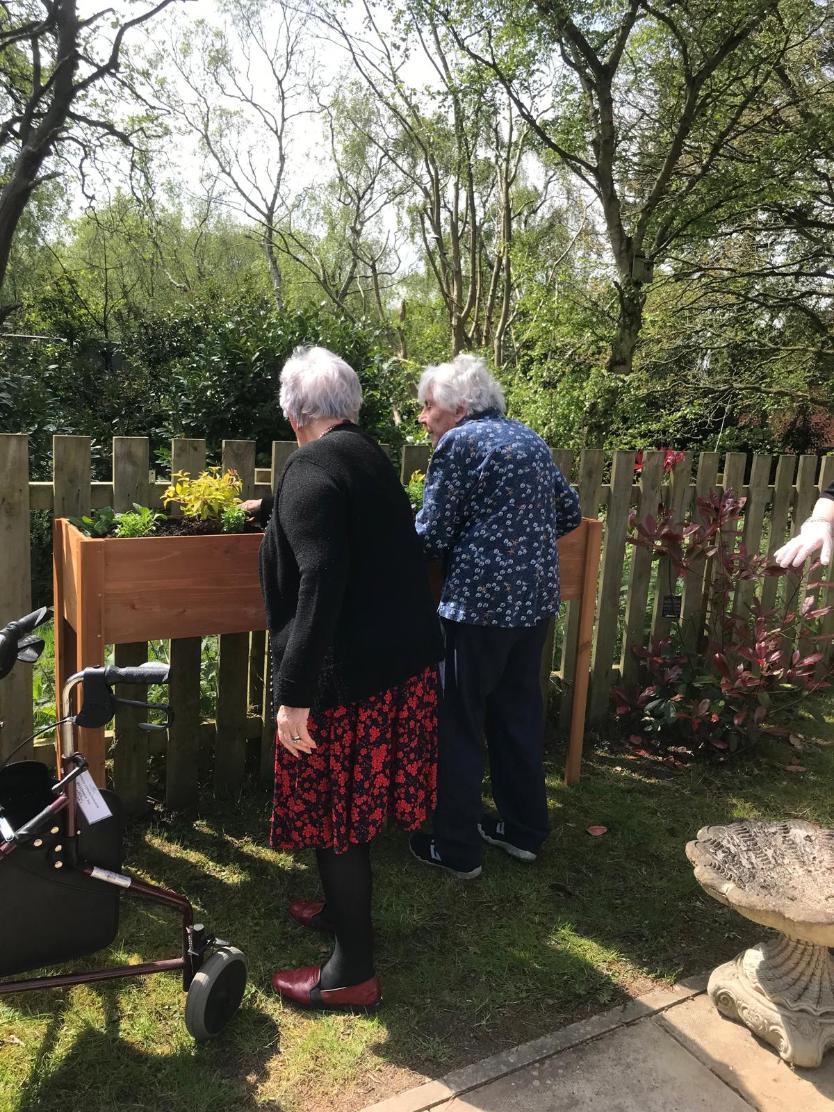 Residents gardening on our raised planters