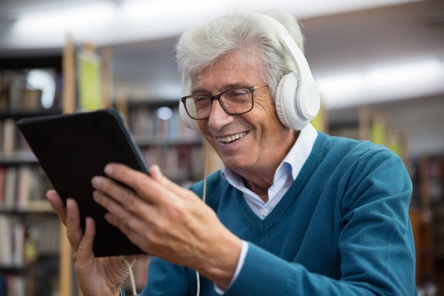 resident on an ipad with headphones