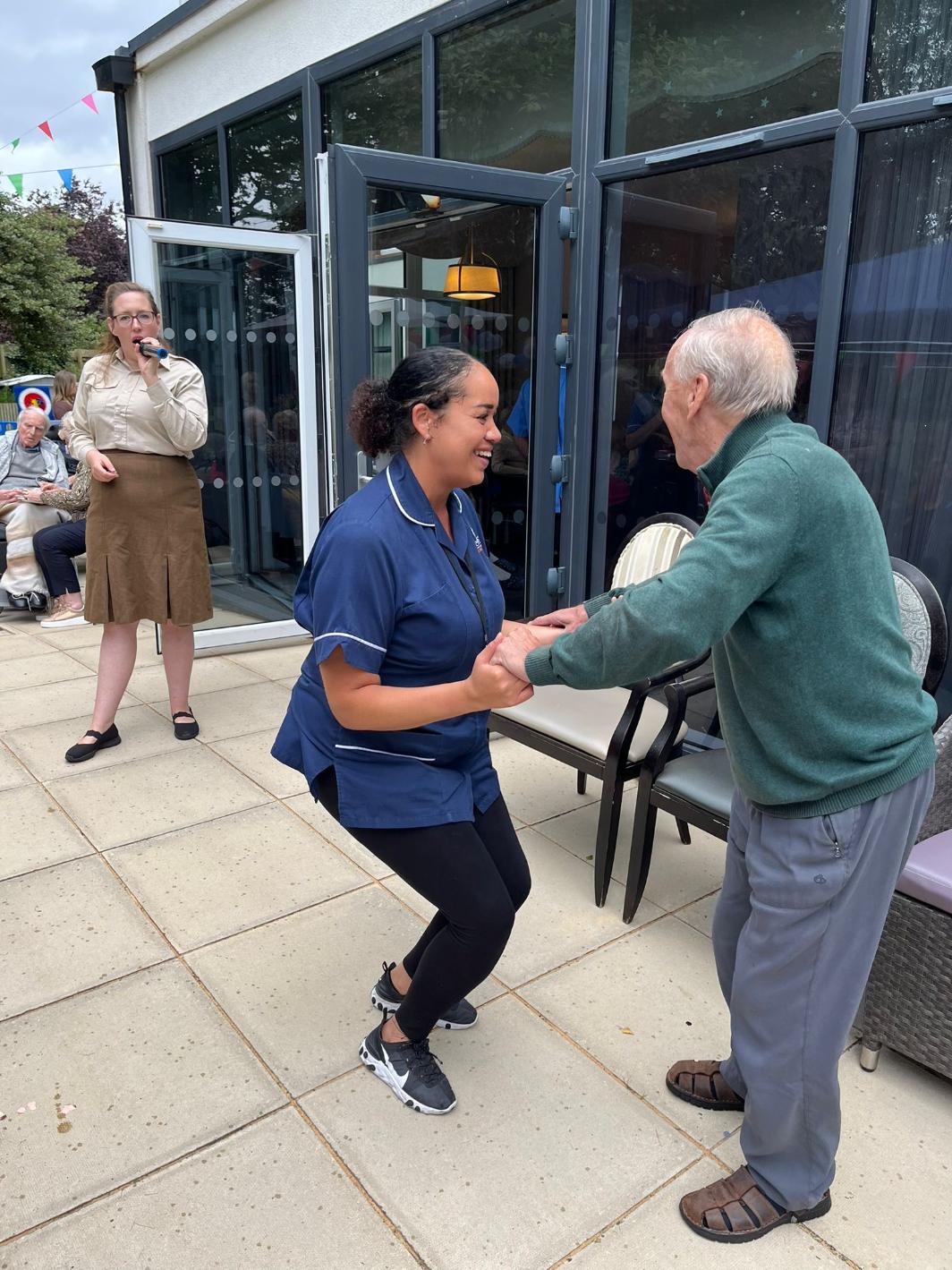 resident dancing with carer