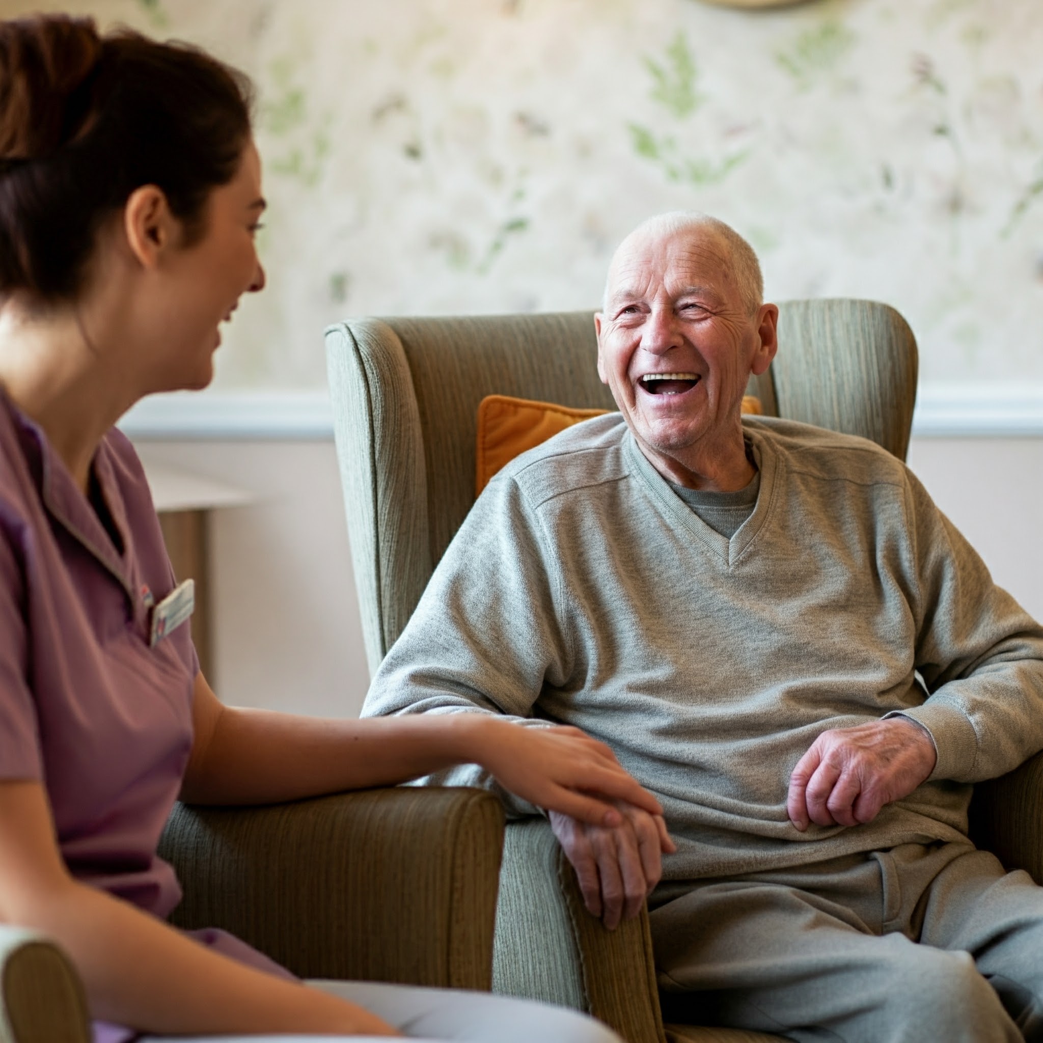 A laughing resident with carer