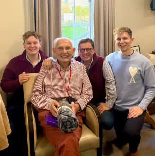 older man with his family