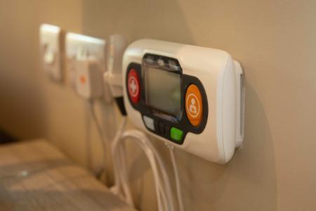 an accessible remote mounted to a wall
